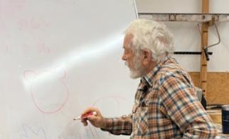 Richard Cale sketching the bowl design at the whiteboard